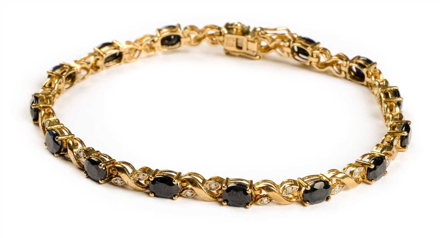 Lot 3 - Bracelet. A 9ct gold ladies bracelet set with 15 sapphires and 30 diamond chippings