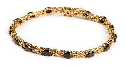 Lot 3 - Bracelet. A 9ct gold ladies bracelet set with 15 sapphires and 30 diamond chippings