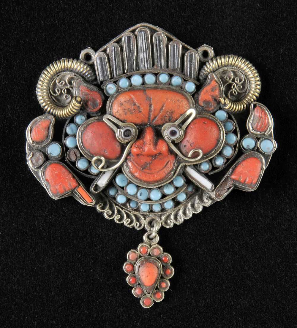 Lot 107 - Pendant. A rare silver and jewelled Tibetan/Newari monster mask drop pendant, 18th/19th century