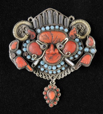 Lot 107 - Pendant. A rare silver and jewelled Tibetan/Newari monster mask drop pendant, 18th/19th century