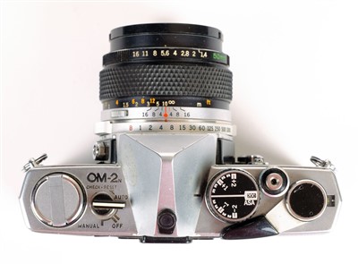 Lot 315 - Olympus OM2n 35mm SLR film camera with Zuiko 50mm f/1.4 prime lens and other lenses