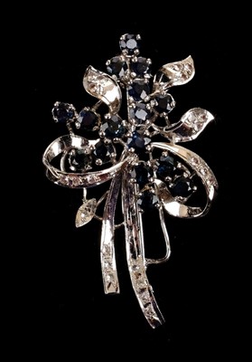 Lot 9 - Brooches. A white metal brooch set with diamonds and sapphires