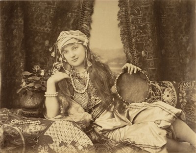 Lot 25 - Turkey. Portrait of a Turkish woman reclining on a divan, by Hippolyte Arnoux, c. 1870