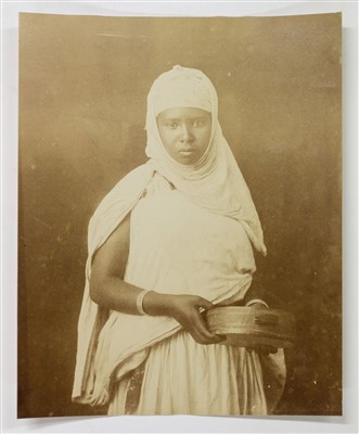 Lot 22 - North Africa. A portrait of a young North African woman holding a tambourine, c. 1880s