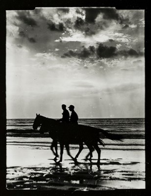 Lot 255 - Munkacsi (Martin). Contact print of two people horseriding on a beach, c. 1930s, printed c. 1960