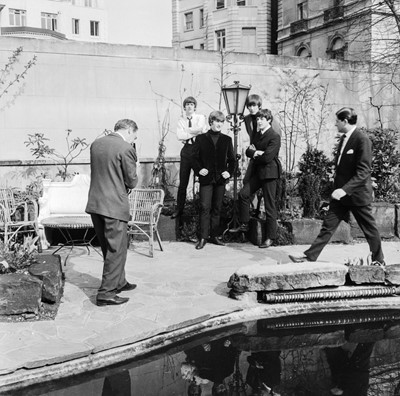 Lot 90 - The Beatles: A Hard Day's Night. The Beatles in the walled garden of Les Ambassadeurs club