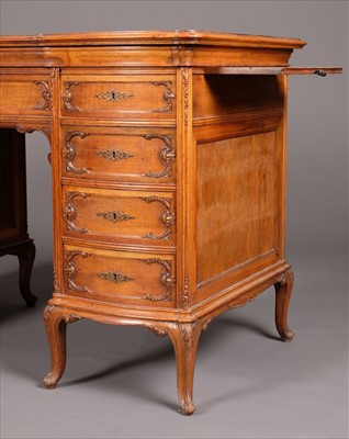 Lot 127 - Desk. A Continental walnut and figured walnut Rococo style kneehole desk, circa 1900