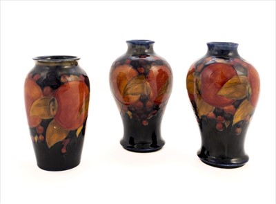 Lot 5 - Moorcroft. A pair of Moorcroft 'Pomegranate' pattern vases