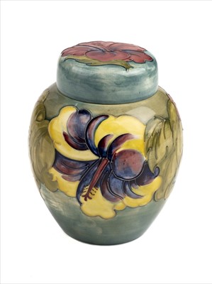 Lot 18 - Moorcroft. A Moorcroft pottery 'Hibiscus' pattern ginger jar and cover