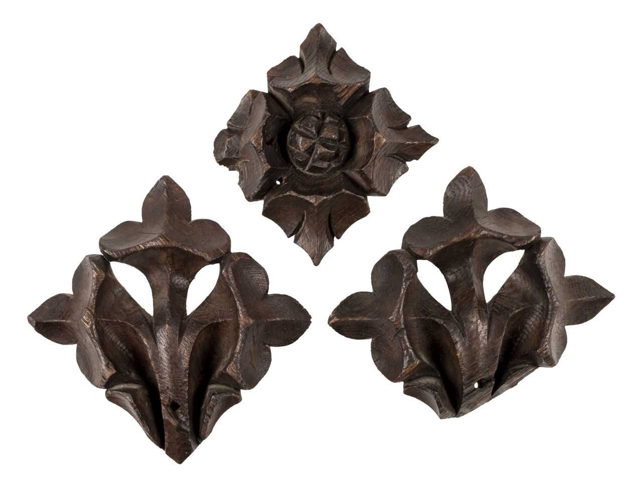 Lot 64 - Oak carvings. A pair of 18th century oak fleur de lys and rosette