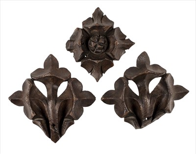 Lot 64 - Oak carvings. A pair of 18th century oak fleur de lys and rosette