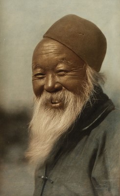 Lot 314 - China. Smiling face of an old man, hand-coloured carbon print, c. 1920s