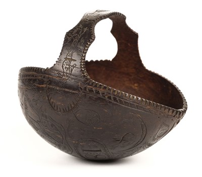 Lot 96 - Coconut basket. A 19th century carved 'bugbear' coconut basket dated 1884