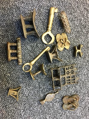 Lot 243 - Ashanti. A collection of gold weights and related items