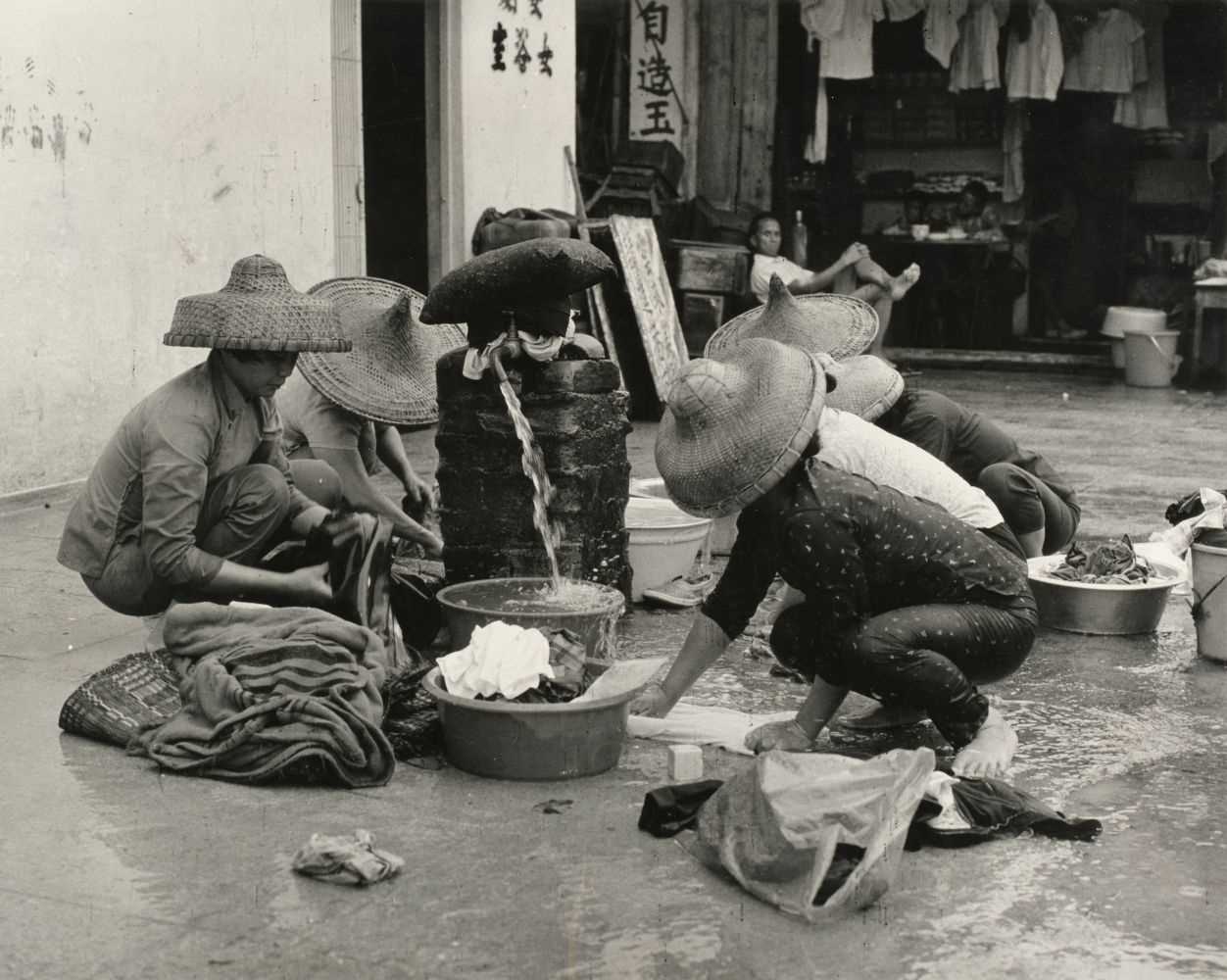 Lot 327 - Hong Kong. Women washing laundry, by Herbert Pollak, gelatin silver print, 1970