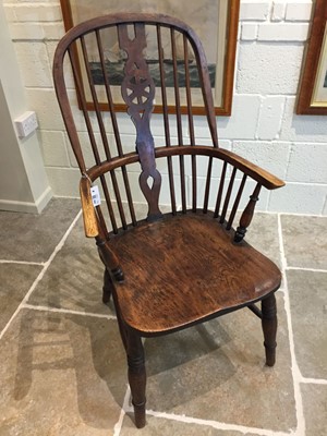 Lot 244 - Armchair. A Victorian elm wheelback armchair