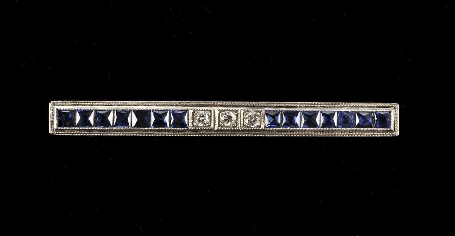 Lot 9 - Brooch. Art Deco diamond and sapphire bar brooch