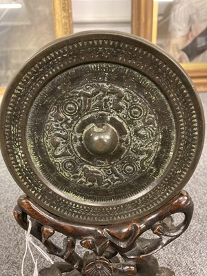 Lot 159 - Chinese. An archaic bronze mirror on a hardwood stand