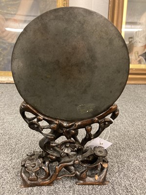 Lot 159 - Chinese. An archaic bronze mirror on a hardwood stand