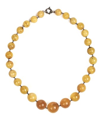 Lot 138 - Amber. Early 20th-century string of butterscotch amber beads