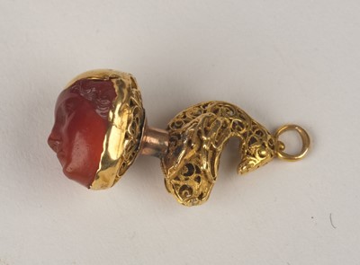 Lot 376 - Fob. An Interesting 19th-century yellow metal fob/pendant with carved carnelian classical head