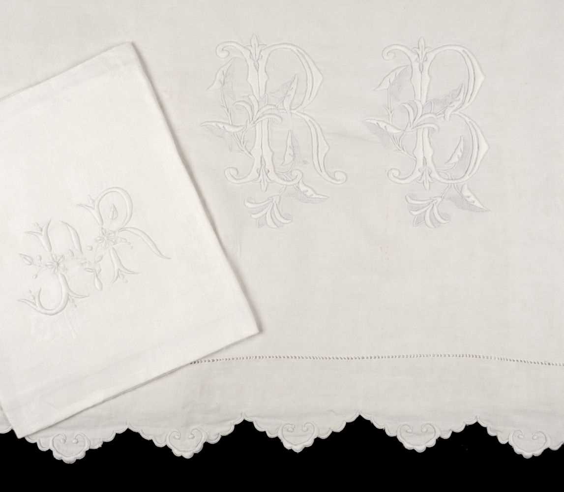 Lot 532 - Bed Linen. A monogrammed French linen sheet, early 20th century, & 12 napkins