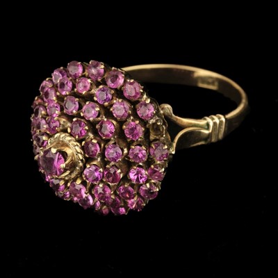 Lot 392 - Pink Sapphire Ring. 14K gold pink sapphire cluster ring