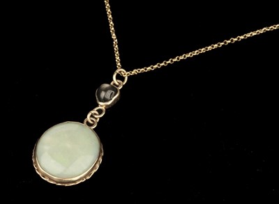 Lot 390 - Opal and Sapphire Pendant. An opal pendant set in yellow metal with a sapphire cabochon