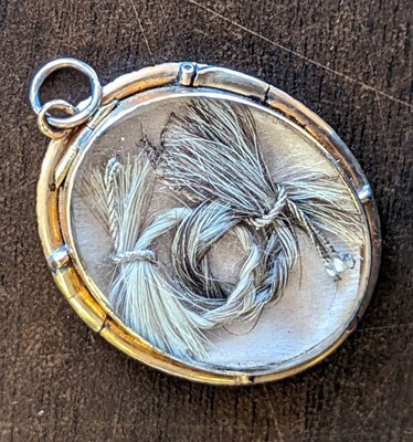 Lot 272 - Hair memento. A mourning pendant in memory of Eunice Denton Bagster (1777-1877), & related textiles