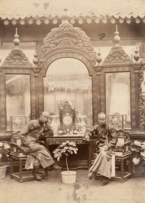 Lot 64 - China. Two Chinese men seated in front of a large mirror, Peking, c. 1890s, albumen print