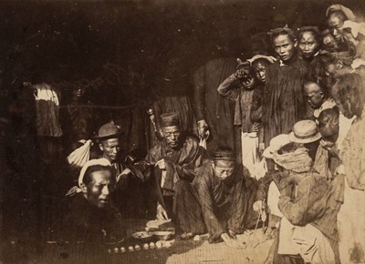 Lot 75 - Indochina. A group of Chinese men and children in a huddled group, c. 1890, albumen print on card