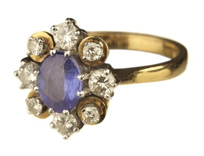 Lot 481 - Ring. An 18ct gold tanzanite and diamond cluster ring