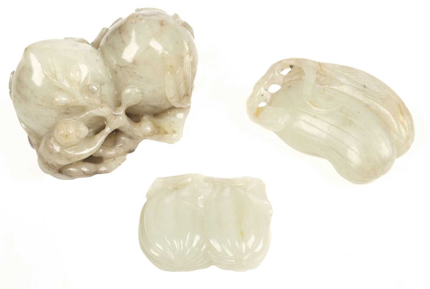 Lot 100 - Jade. Three Chinese carved jade fruit