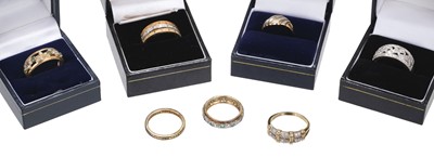 Lot 487 - Rings. A modern 9ct gold three-tone ring set with diamond chippings, size R, 3.9g