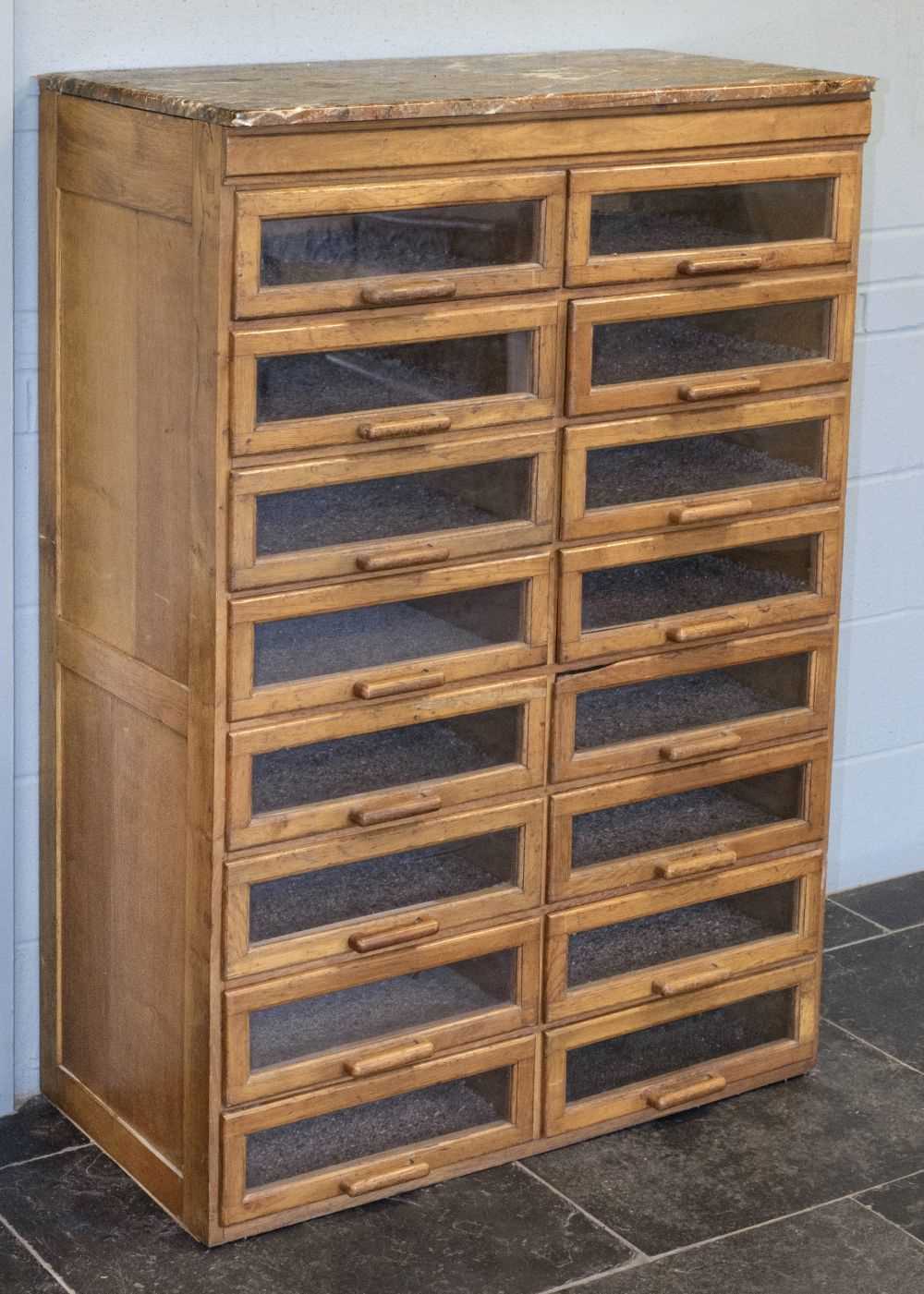 Lot 194 - Shop Cabinet. An early 20th century oak haberdashery bank of 16 drawers