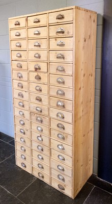 Lot 195 - Shop Cabinet. An early 20th century pine shop keepers bank of 48 drawers