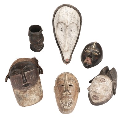 Lot 458 - Tribal Art. A collection of African tribal masks and cup