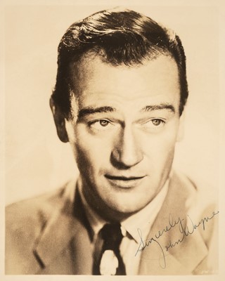 Lot 276 - Wayne (John, 1907-1979). A vintage signed photograph