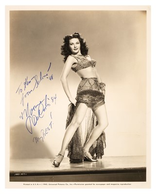 Lot 212 - De Carlo (Yvonne, 1922-2007). A signed and inscribed glossy publicity photograph, 1945