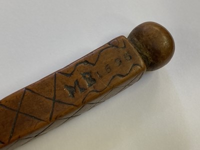 Lot 457 - Treen. A 17th century treen apple corer dated 1696