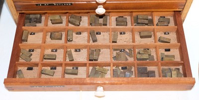 Lot 220 - Type and type cabinet. Six sets of brass type
