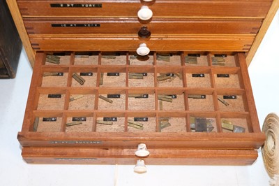 Lot 220 - Type and type cabinet. Six sets of brass type