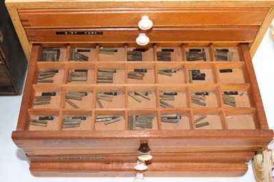 Lot 220 - Type and type cabinet. Six sets of brass type