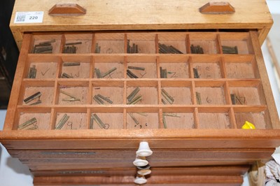 Lot 220 - Type and type cabinet. Six sets of brass type