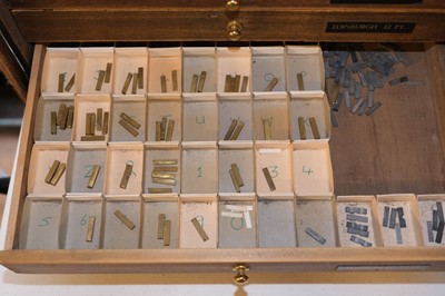 Lot 218 - Type and type cabinet. Five sets of brass type
