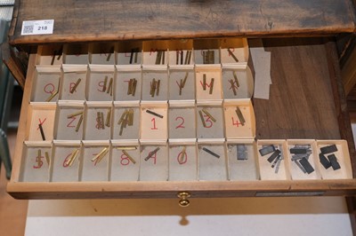 Lot 218 - Type and type cabinet. Five sets of brass type