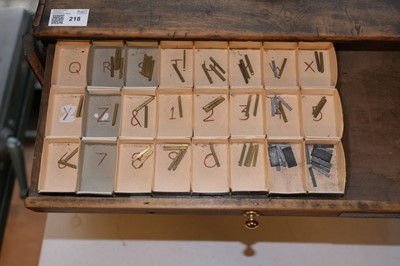 Lot 218 - Type and type cabinet. Five sets of brass type