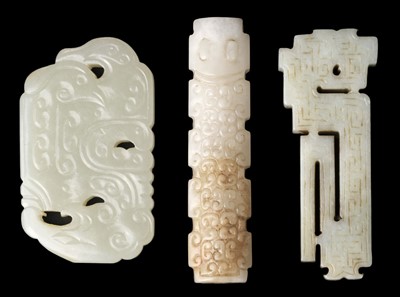 Lot 489 - Jade. A Chinese white jade toggle and two panels