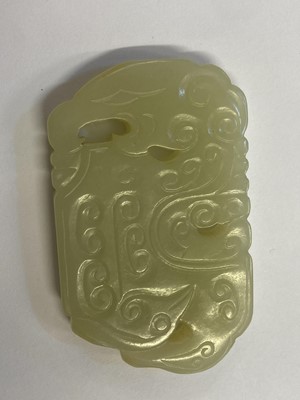 Lot 489 - Jade. A Chinese white jade toggle and two panels