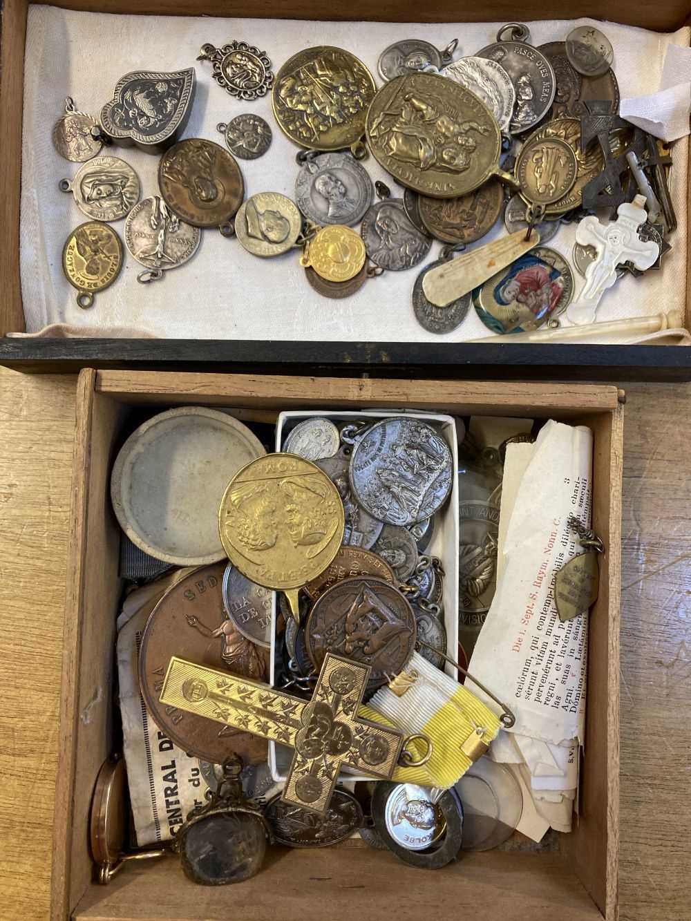 Lot 450 - Religious Artefacts. A Victorian yellow metal cross and religious medals